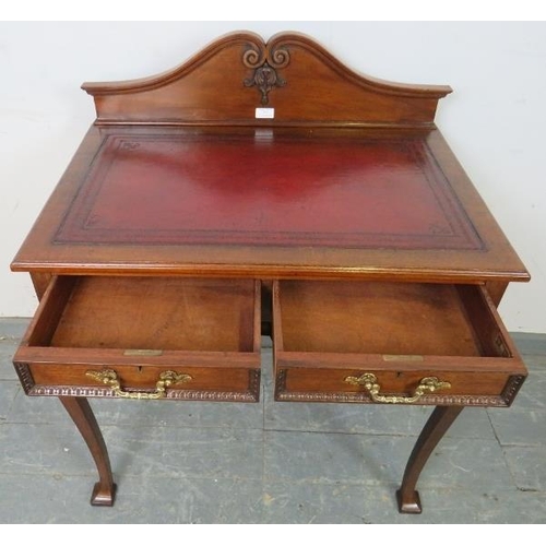 707 - A vintage 19th century style mahogany writing table by Maple & co, with inset burgundy leather writi... 