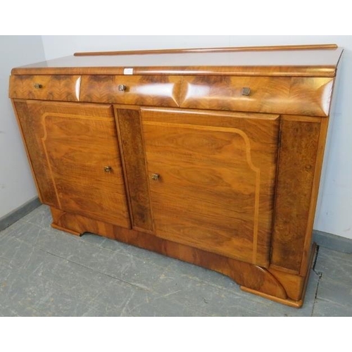 708 - An Art Deco walnut sideboard, housing three short drawers above two cupboards, with phenolic Bakelit... 