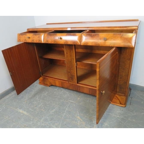 708 - An Art Deco walnut sideboard, housing three short drawers above two cupboards, with phenolic Bakelit... 