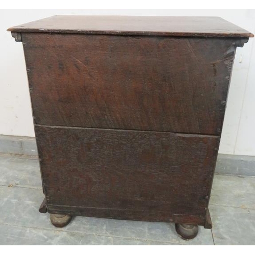 717 - A good 17th century oak spice cupboard, the door with geometric mouldings opening onto a configurati... 