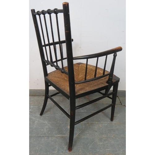 720 - A 19th century ebonised beech William Morris ‘Sussex’ chair, with rush seat, on tapering supports wi... 