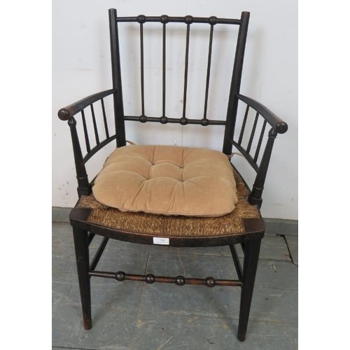 720 - A 19th century ebonised beech William Morris ‘Sussex’ chair, with rush seat, on tapering supports wi... 