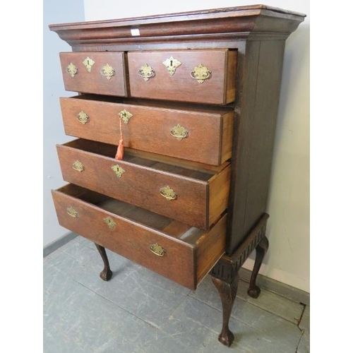 723 - An 18th century oak chest on stand, housing two short over three long drawers with fancy brass lock ... 