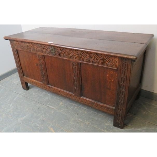 724 - An early 18th century panelled oak coffer with internal candle box, the lid retaining original butte... 