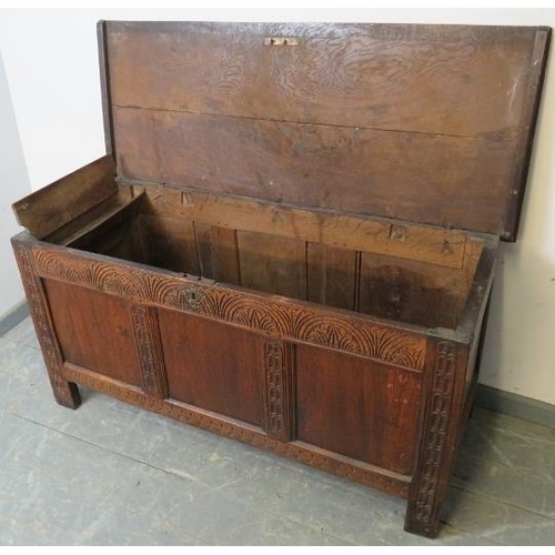 724 - An early 18th century panelled oak coffer with internal candle box, the lid retaining original butte... 