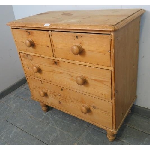 727 - An antique pine chest of two short over two long drawers with turned knob handles, on turned support... 