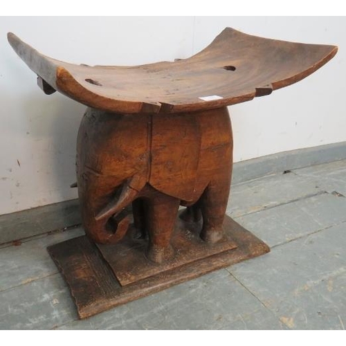 748 - A vintage teak stool in the form of an elephant, on a plinth base. 
H51 W54 D32
Condition report: So... 