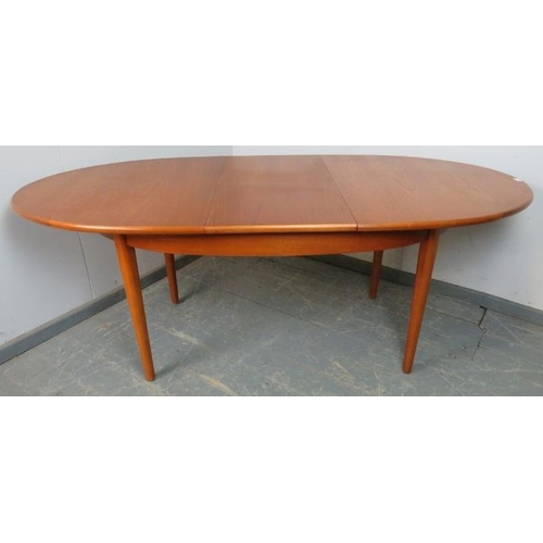 757 - A mid-century teak oval extending dining table by G-Plan, with butterfly folding central leaf, on ta... 