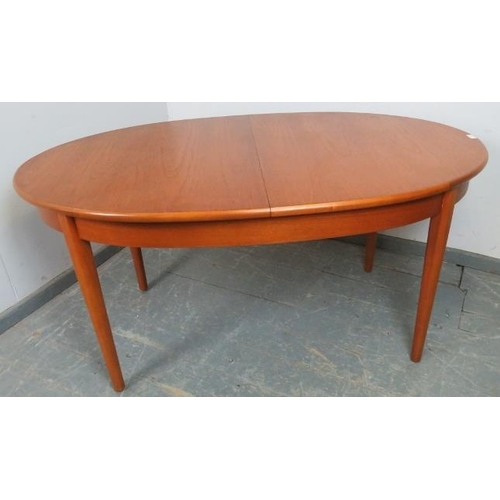 757 - A mid-century teak oval extending dining table by G-Plan, with butterfly folding central leaf, on ta... 