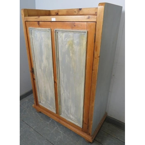 759 - An antique Continental pine side cabinet painted grey and distressed, the panelled door opening onto... 