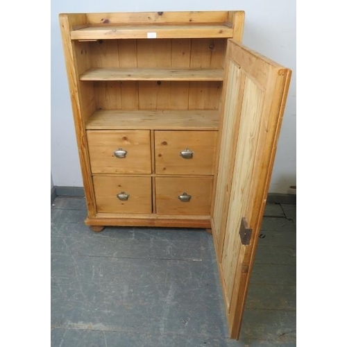 759 - An antique Continental pine side cabinet painted grey and distressed, the panelled door opening onto... 