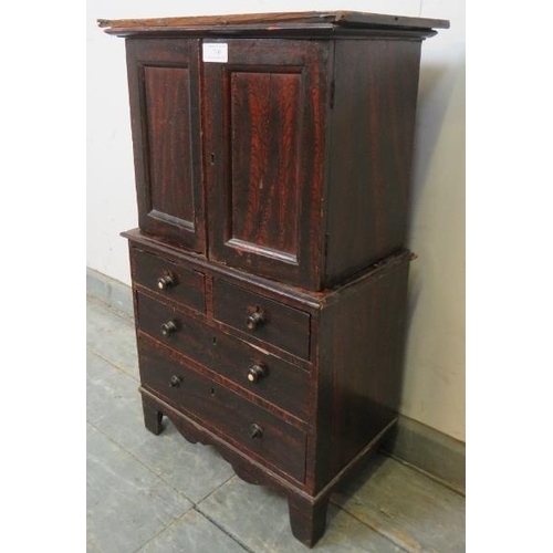 760 - An antique stained pine apprentice piece linen press, the top section with shelf above two short dra... 