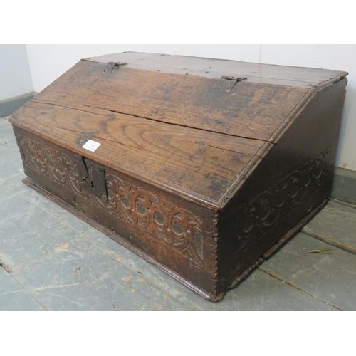 768 - A 17th century oak bible box retaining the original cast iron hinges and lock mechanism, with relief... 