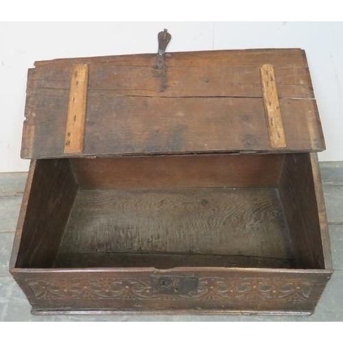 768 - A 17th century oak bible box retaining the original cast iron hinges and lock mechanism, with relief... 