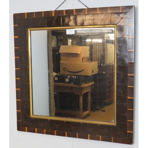 770 - A vintage square wall mirror within a parcel gilt surround featuring tiled specimen wood decoration.... 