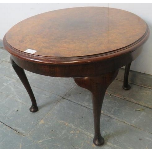 773 - An antique burr walnut circular coffee table, the quarter veneered top with central roundel, on cabr... 