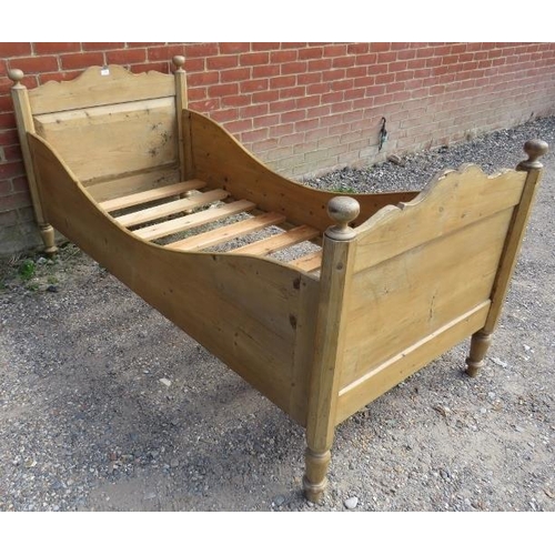 778 - An antique   stripped pine single sleigh bed, with ball finials, on tapering turned supports. 
H92 W... 