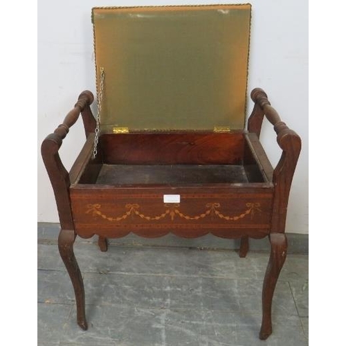 779 - An Edwardian mahogany piano stool, the green velvet seat opening onto a storage well, with marquetry... 