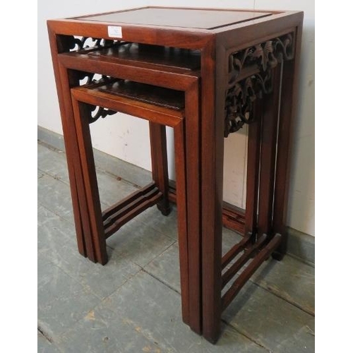 782 - A set of three Chinese walnut nesting tables, with fielded burr walnut inset tops and foliate carved... 