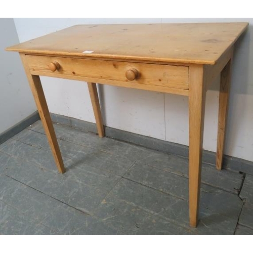 787 - An antique stripped pine side table housing one long drawer with turned wooden handles, on tapering ... 