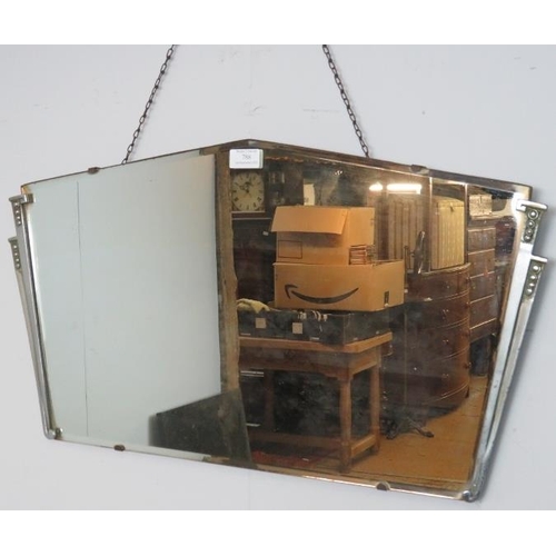 788 - An Art Deco bevelled wall mirror with cast aluminium side detail. 
H38 W70
Condition report: No issu... 