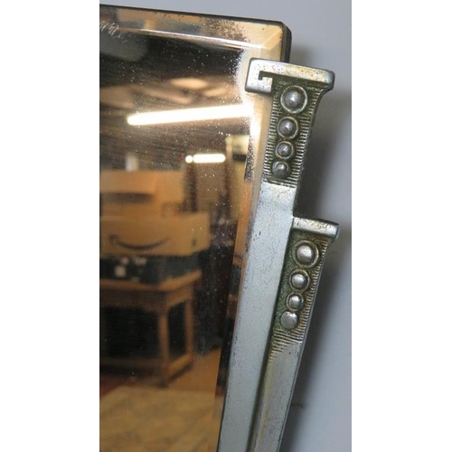 788 - An Art Deco bevelled wall mirror with cast aluminium side detail. 
H38 W70
Condition report: No issu... 