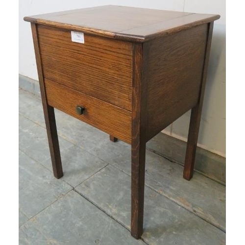 790 - An Art Deco Period oak sewing table, the hinged lid opening onto a gold silk lined interior, above a... 