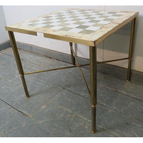 794 - A vintage games table with onyx and marble chessboard top, on tapering gilt brass supports united by... 