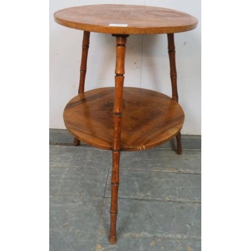 797 - A vintage walnut circular two-tier table, on canted faux bamboo tripod supports. 
H63 Diameter 44
Co... 