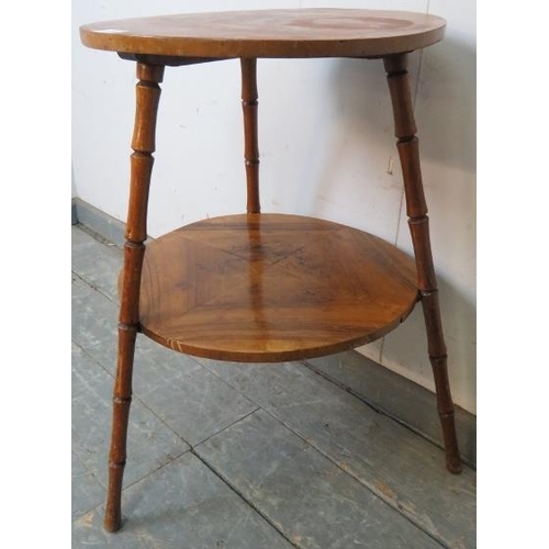 797 - A vintage walnut circular two-tier table, on canted faux bamboo tripod supports. 
H63 Diameter 44
Co... 