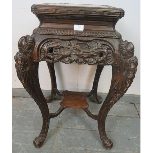 799 - An antique Chinese hardwood plant stand with ornately carved and pierced frieze, on carved cabriole ... 