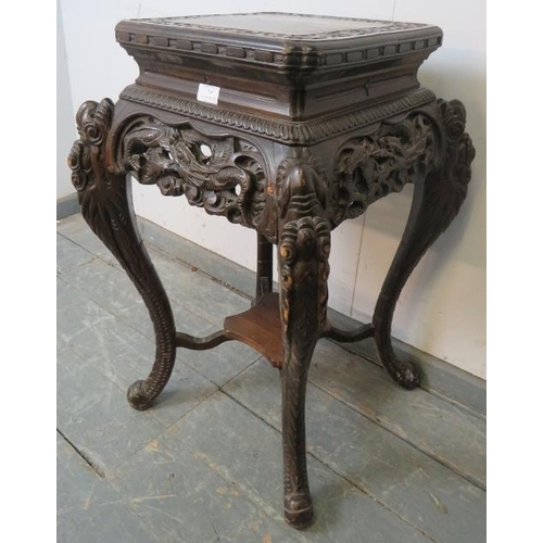 799 - An antique Chinese hardwood plant stand with ornately carved and pierced frieze, on carved cabriole ... 