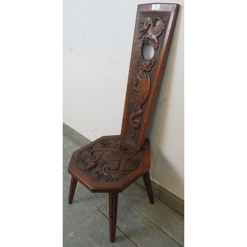 800 - A vintage oak spinning stool with high relief carving to backrest and seat depicting dragons, on ree... 