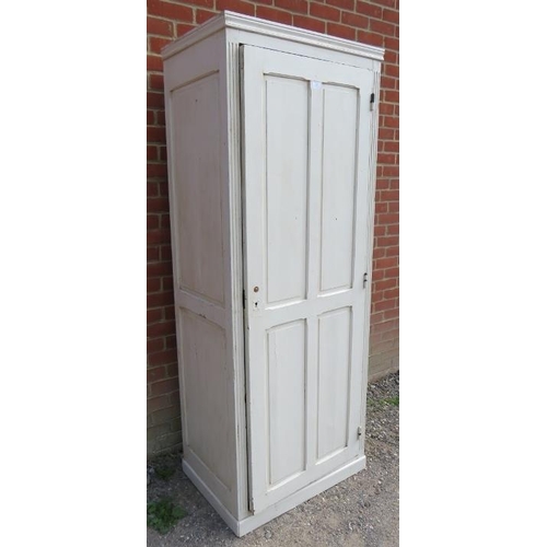 803 - An antique pitch pine tall pantry cupboard painted white, the panelled door opening onto three loose... 