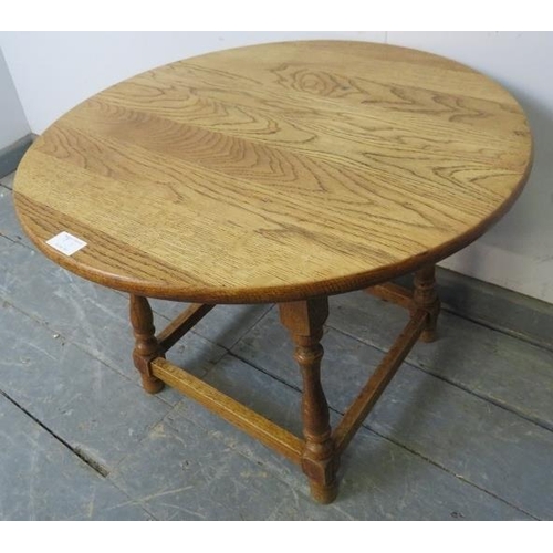 807 - A vintage light oak circular occasional table in the 18th century taste, on baluster turned supports... 