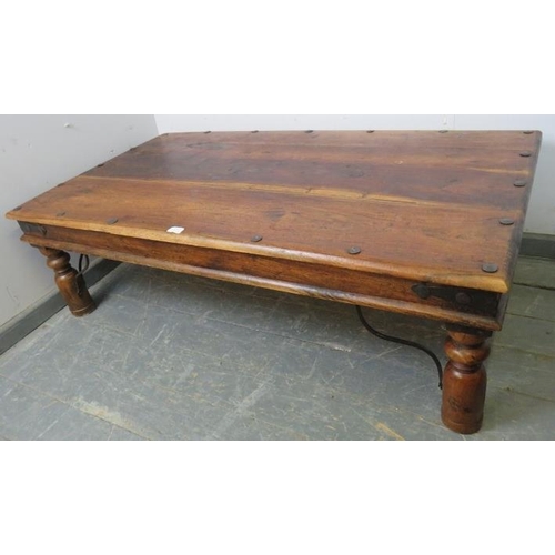 811 - A mango wood rectangular Thakat coffee table with wrought iron mounts, on turned supports. 
H43cm W1... 