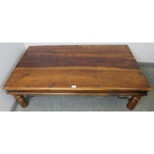 811 - A mango wood rectangular Thakat coffee table with wrought iron mounts, on turned supports. 
H43cm W1... 