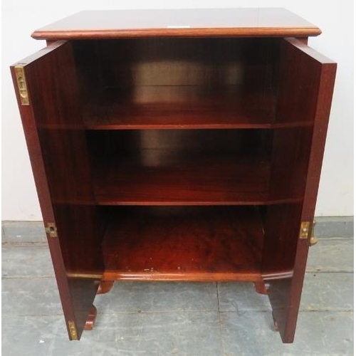 819 - An antique flame mahogany side cabinet, the twin cock-beaded doors opening onto two fitted shelves, ... 