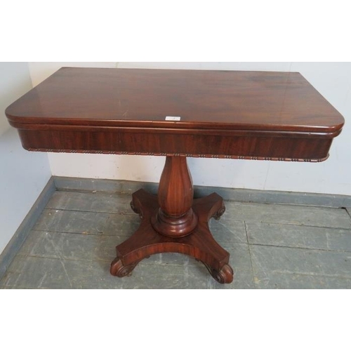 826 - A Victorian mahogany turnover tea table, on an octagonal baluster pedestal, above a quatreform base ... 