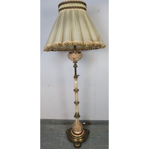 827 - An ornate vintage brass and ceramic height adjustable standard lamp, on a circular plinth base with ... 