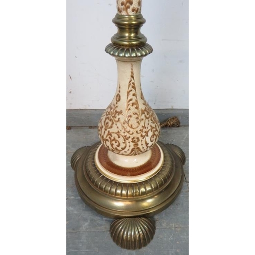 827 - An ornate vintage brass and ceramic height adjustable standard lamp, on a circular plinth base with ... 