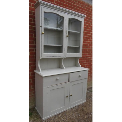 838 - An antique pine kitchen dresser painted grey, the glazed doors opening onto two fitted shelves, the ... 