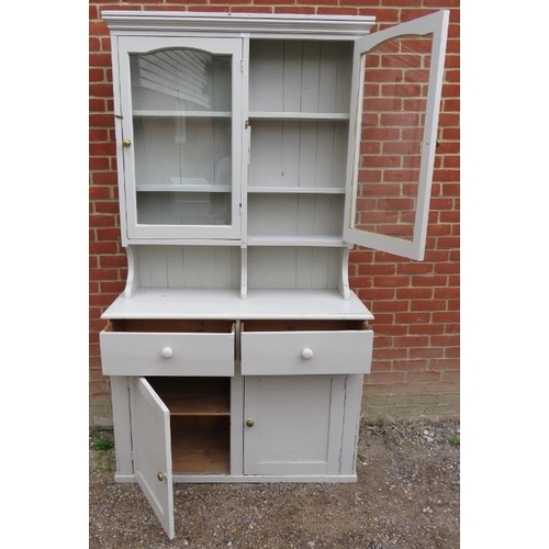 838 - An antique pine kitchen dresser painted grey, the glazed doors opening onto two fitted shelves, the ... 