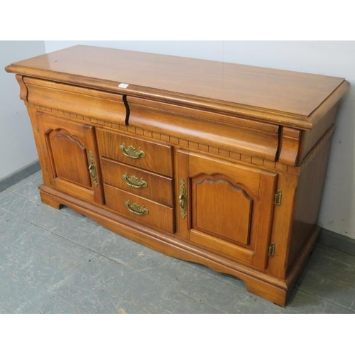 851 - A vintage antique-style walnut sideboard, housing two blind drawers above three short drawers and tw... 