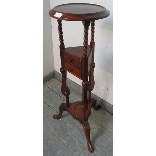 857 - A reproduction mahogany wig/plant stand in the Georgian taste, with dished top, raised on barley twi... 