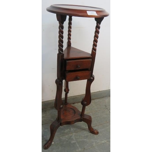 857 - A reproduction mahogany wig/plant stand in the Georgian taste, with dished top, raised on barley twi... 