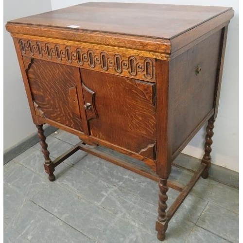 861 - A 1920s oak cased floor-standing gramophone by Atlas, on barley twist supports with an ‘H’ stretcher... 