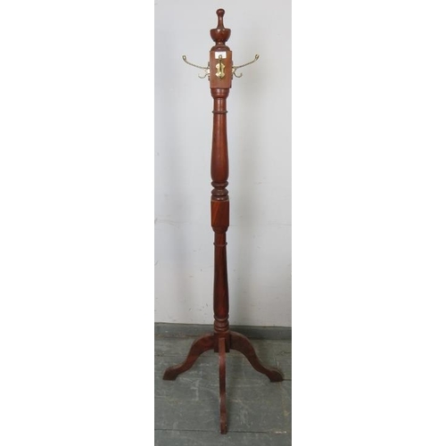 864 - A reproduction hardwood coat-stand in the Victorian taste, with turned centre finial above four bras... 