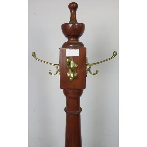 864 - A reproduction hardwood coat-stand in the Victorian taste, with turned centre finial above four bras... 