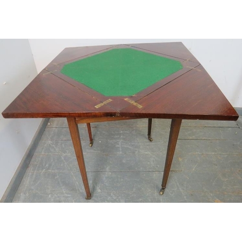 867 - An Edwardian mahogany envelope card table, crossbanded and strung with boxwood and ebony, housing on... 